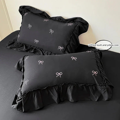 Black satin pillowcases with white bow embroidery and ruffled edges from decorbites bow embroidery bedding set