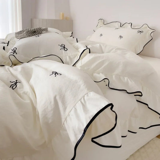 White bedding set with black bow embroidery and ruffled edges from decorbites™ bow embroidery bedding set