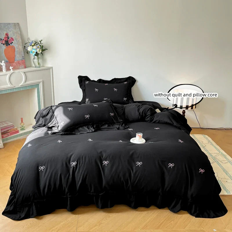 Black satin bow embroidery bedding set with delicate white bows and ruffled edges by decorbites