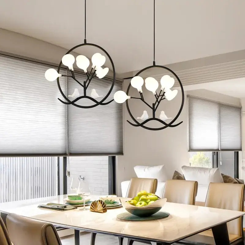 Decorbites branch iron black gold chandelier featuring tree-shaped pendant lights with white globe bulbs and bird figures
