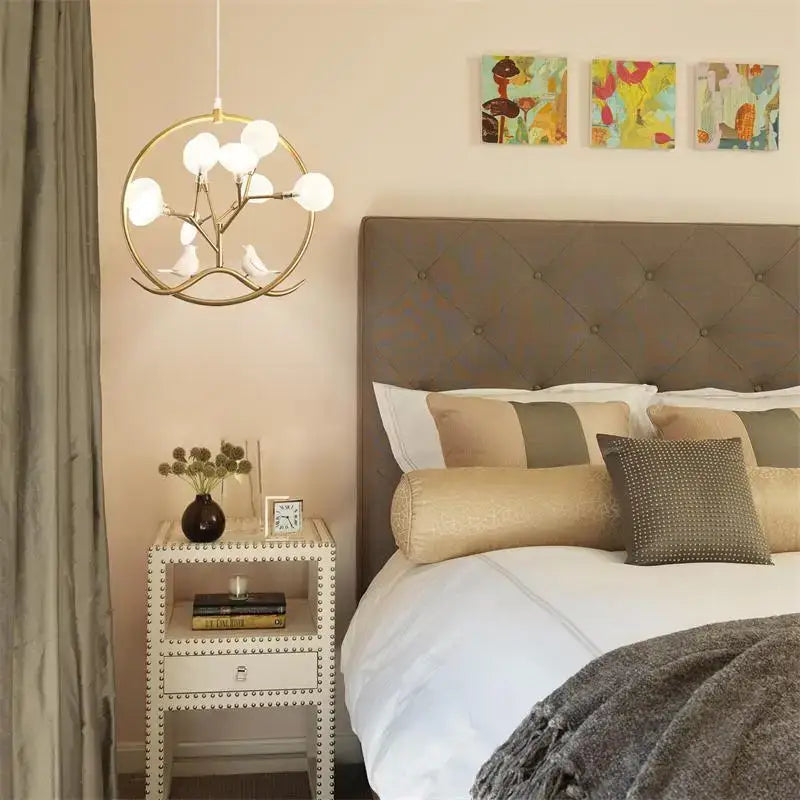 Gold-toned decorbites branch iron black gold chandelier with white globe bulbs and decorative bird figures for living room