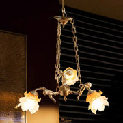 Gold-toned decorbites brass angel chandelier with three flower glass shades and sculptural figures for living room