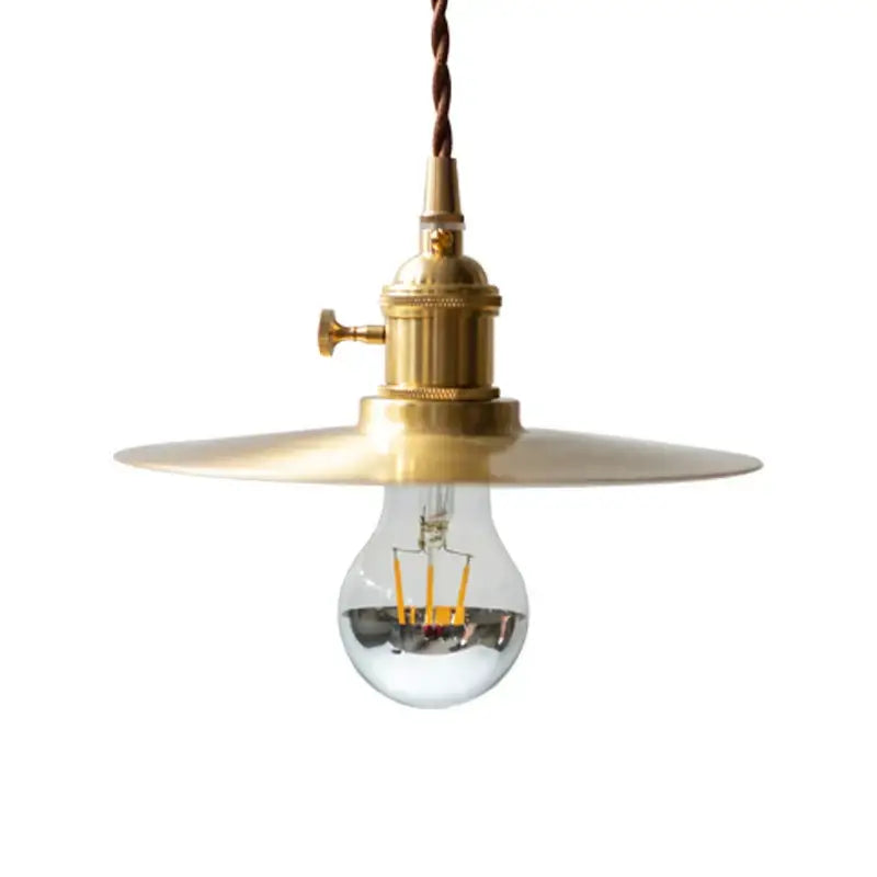 A brass chandelier featuring a wide flat shade and exposed Edison bulb for industrial dining room lighting by Decorbites brass