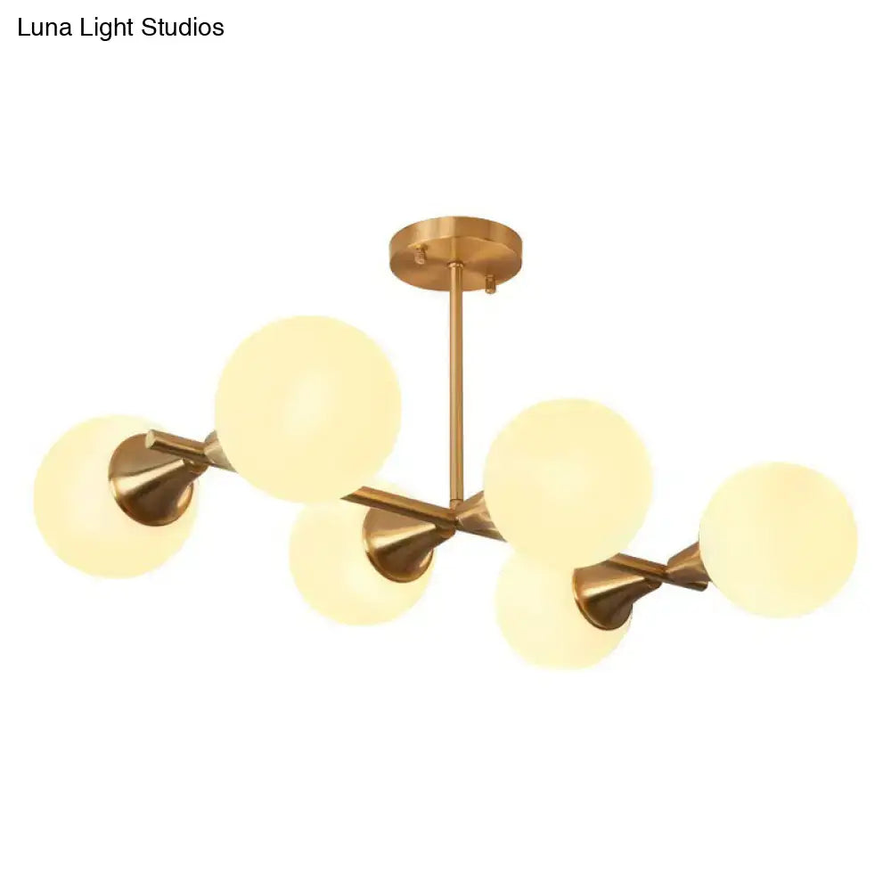Modern brass finish linear island pendant with six frosted white clear glass ball shades by decorbites