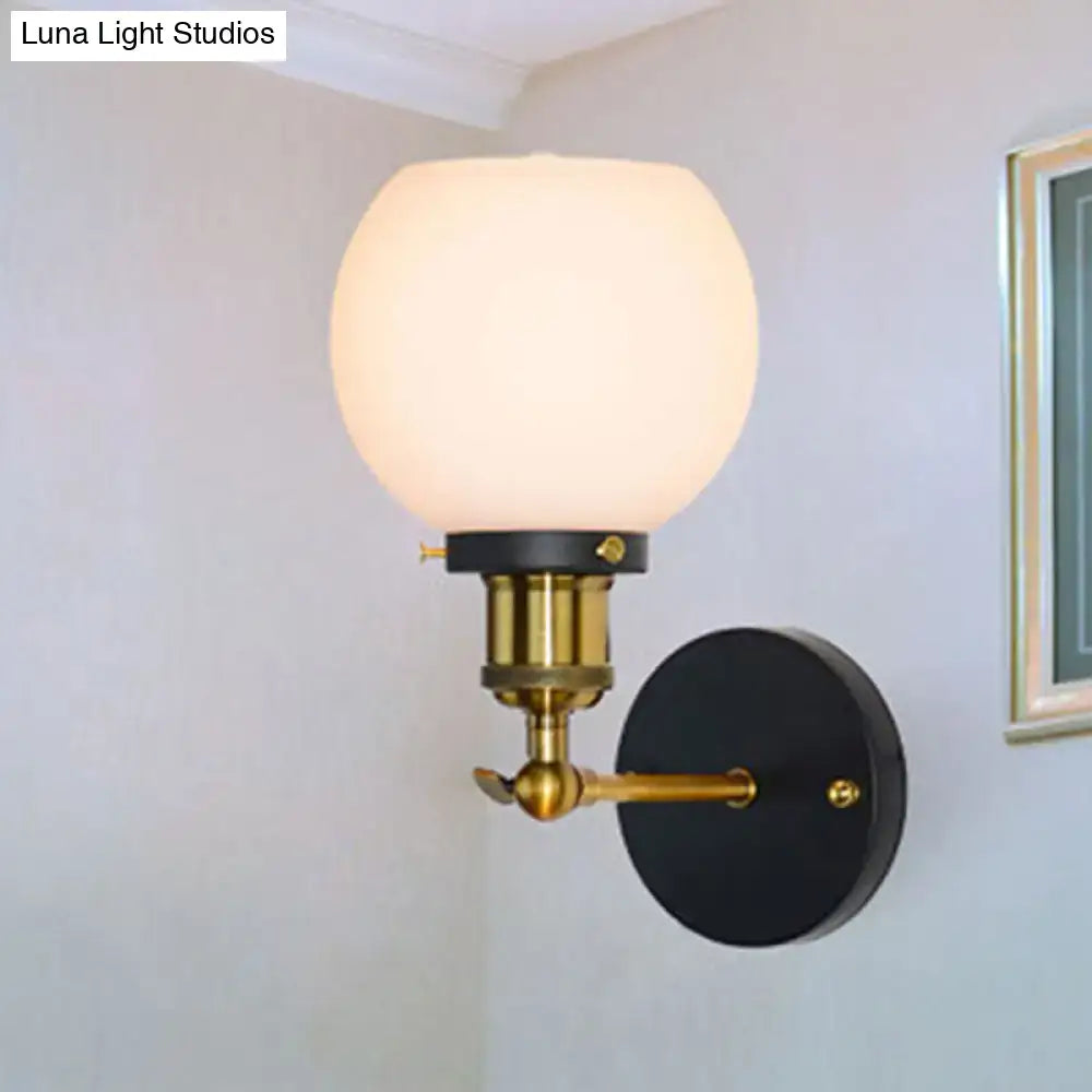 Industrial brass wall sconce with bubble white glass globe brass hardware and black backplate for bedroom lighting