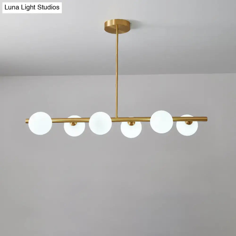 DecorBites brass island pendant light with six frosted glass globes in linear design for dining room ceiling light
