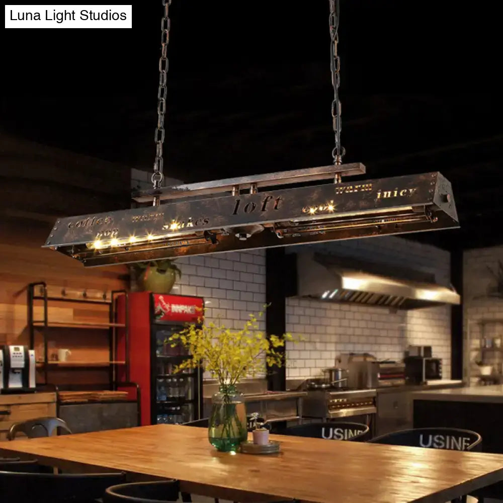 DecorBites brass island pendant light with industrial metal frame, etched lettering, chain suspension, and warm led lighting