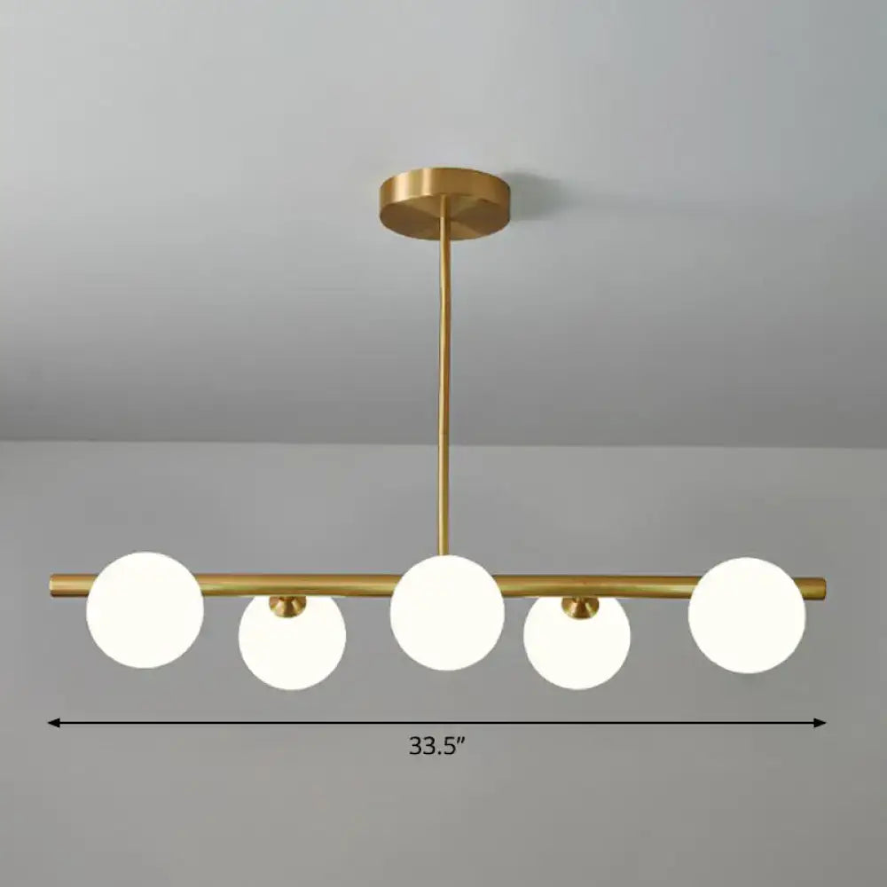 DecorBites brass plated sphere island pendant light with five clear white glass sphere island globe shades for dining room