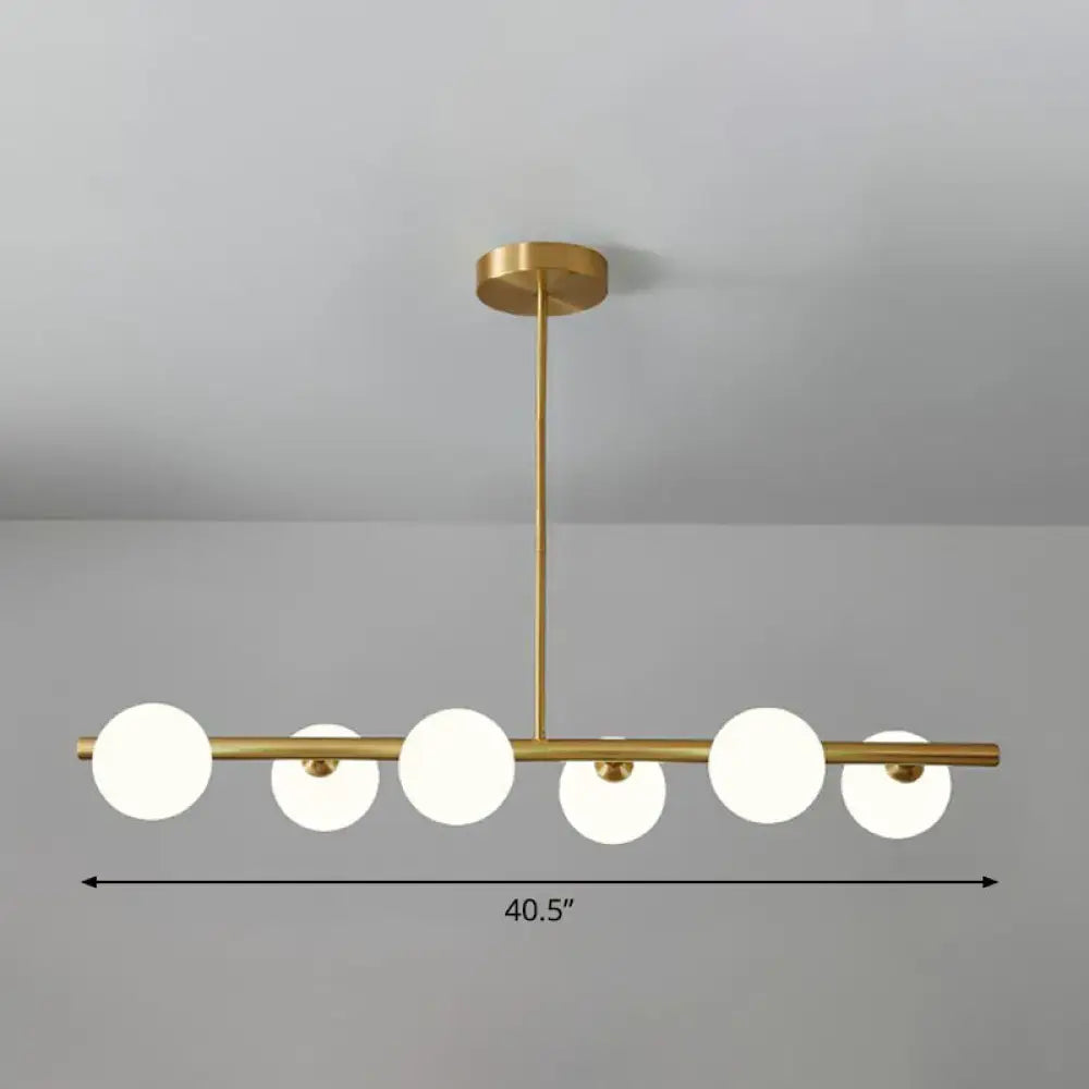 DecorBites brass plated glass sphere island pendant light with five gold-toned clear white frosted glass globes