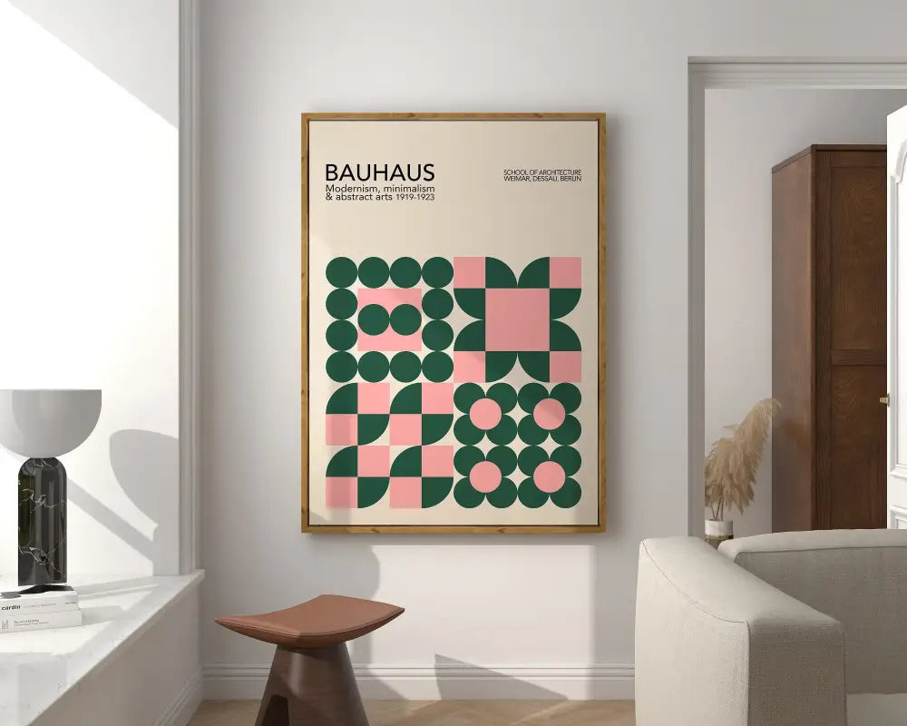 A framed decorbites bright geometric bauhaus canvas art print with green and pink design in a light wood frame