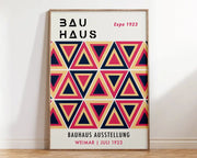 A framed DecorBites™ Bright Geometric canvas art print with mid century bauhaus overlapping navy blue coral pink triangles