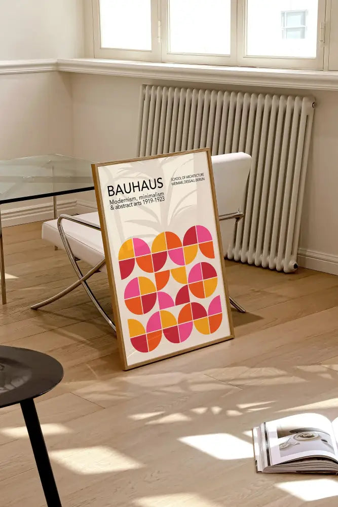 A framed bauhaus poster with bright orange and pink overlapping circles as geometric canvas prints for home decor