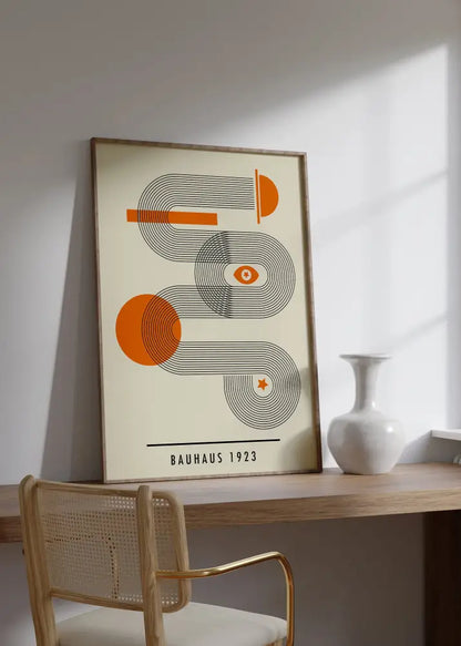 A framed DecorBites bright geometric wall art canvas print featuring an orange and black bauhaus design on cream background
