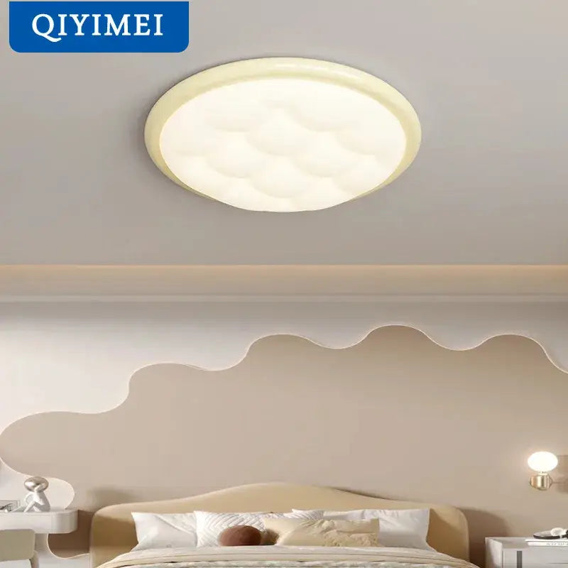 Cream-colored round ceiling light with cloud-like texture and beveled edge in the decorbites bubble led collection