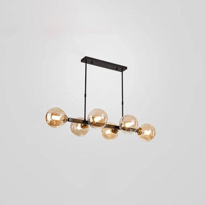 Modern black metal pendant light with five amber glass globe bulbs featuring stylish light features for dining