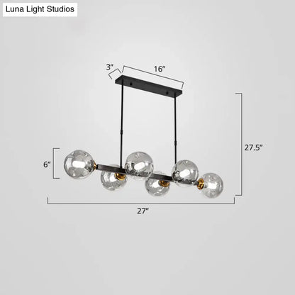 Modern black metal pendant light with five clear glass globe bulbs and gold-toned accents for stylish dining decor