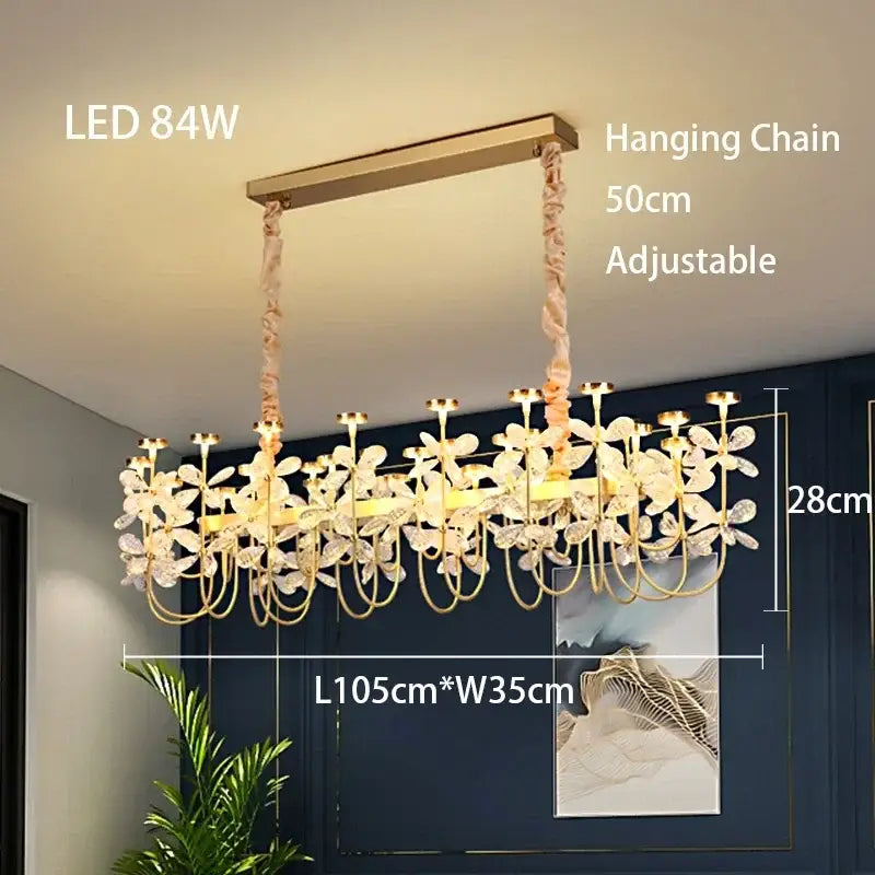 Gold-toned decorbites butterfly chandelier with delicate floral crystal accents and adjustable hanging chain for dining room