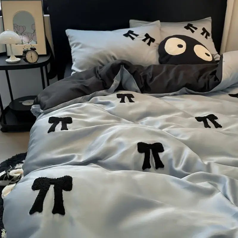 Light gray satin-like comforter with black fuzzy pi symbol embroidery featured in decorbites butterfly embroidered ice silk decor