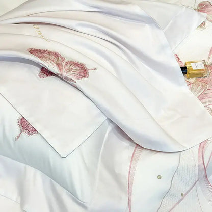 White satin pillowcase with delicate pink decorbites butterfly embroidery and subtle lace trim from luxury bedding set