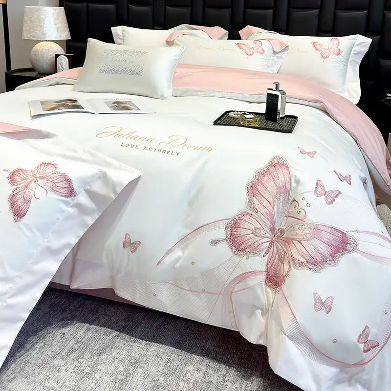 White satin bedding set with pink butterfly embroidery and gold script detailing from decorbites butterfly embroidery collection