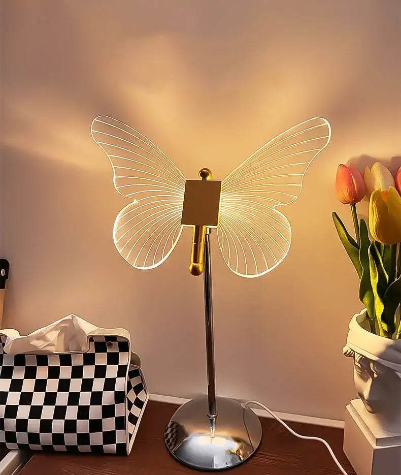 A sleek decorbites butterfly gold acrylic desk lamp with translucent wings and polished gold column for living room