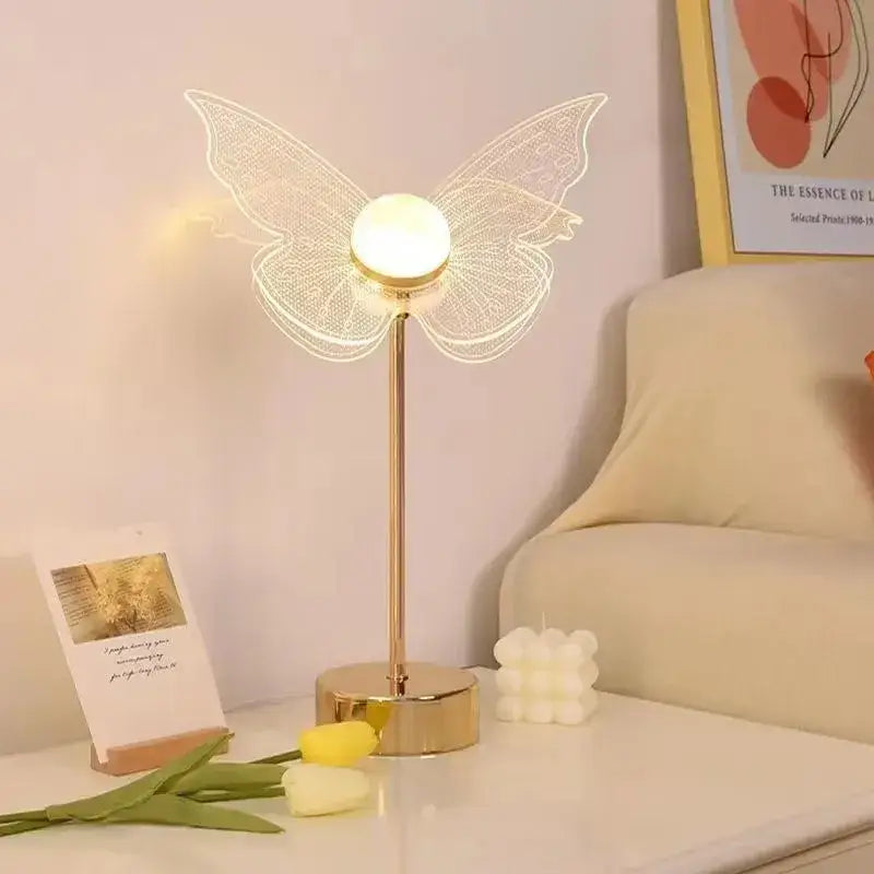 Decorbites butterfly gold acrylic led desk lamp featuring gold-toned butterfly wings and glowing spherical bulb for living room