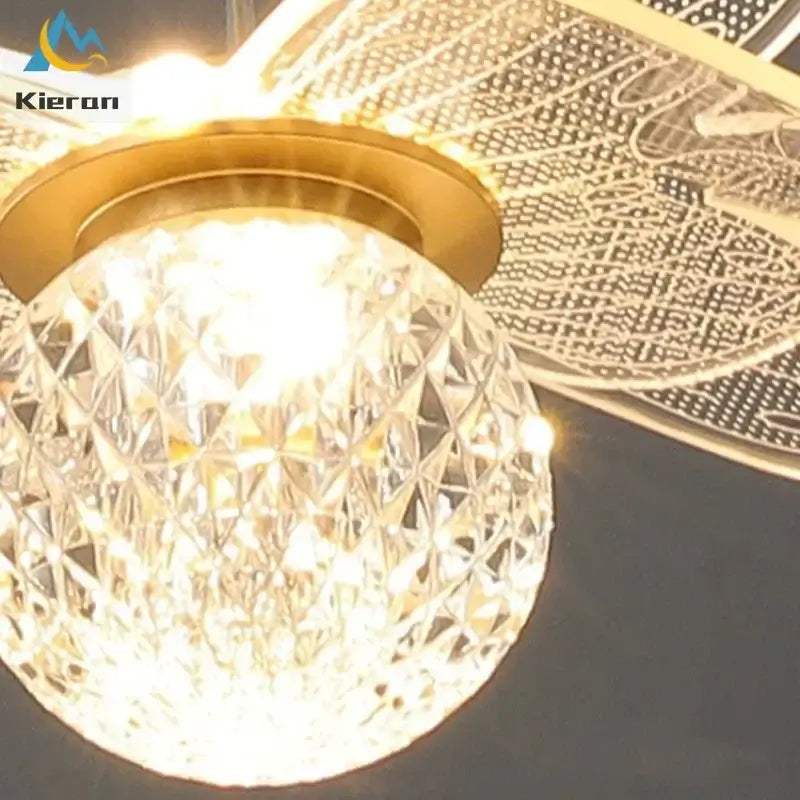 A golden-finished pendant light with crystal-encrusted globe and ornate blades from decorbites butterfly led chandelier