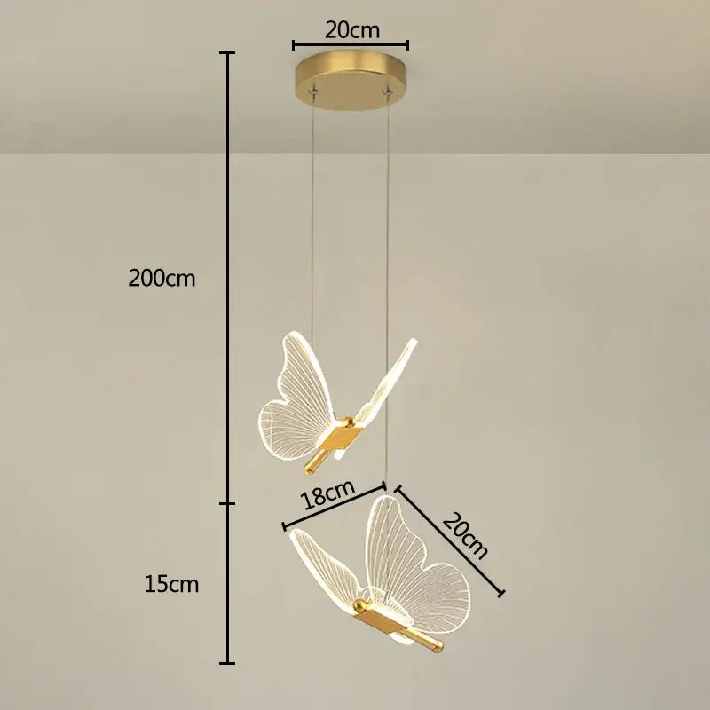 Gold-finished decorbites butterfly pendant light with translucent wireframe wings for modern dining room decor