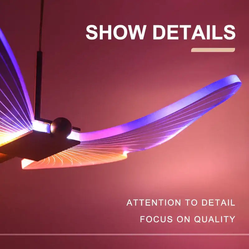 A sleek modern gold decorbites butterfly pendant light with wing design emitting purple and orange hues for dining room