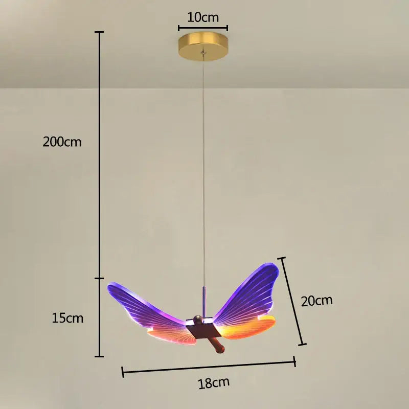 Vibrant decorbites butterfly pendant light with iridescent purple and orange wings hanging from gold ceiling mount