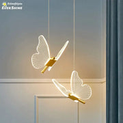 Two elegant translucent butterfly pendant lights with gold metallic bodies by decorbites for dining room lighting