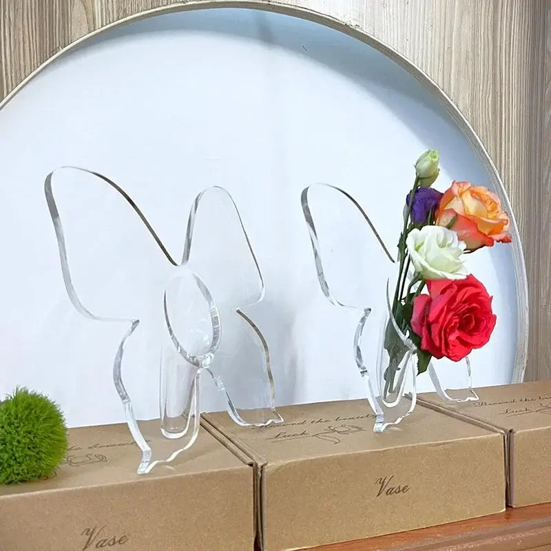 Clear acrylic butterfly vase holding a colorful rose bouquet for aesthetic room decor by DecorBites