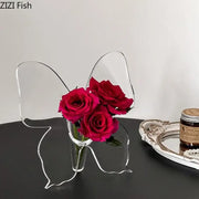 Clear acrylic butterfly vase holding vibrant red roses ideal for aesthetic room decor by DecorBites™