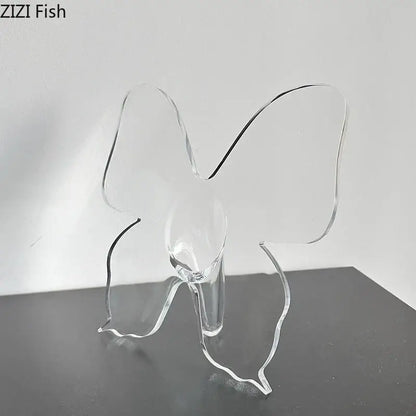 Clear acrylic butterfly vase with transparent wings and sleek base for aesthetic room decor by DecorBites™