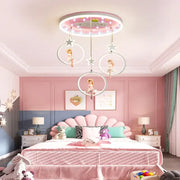 Pink circular led ceiling light with hanging doll figures in white hoops decorbites cartoon princess chandelier for kids room