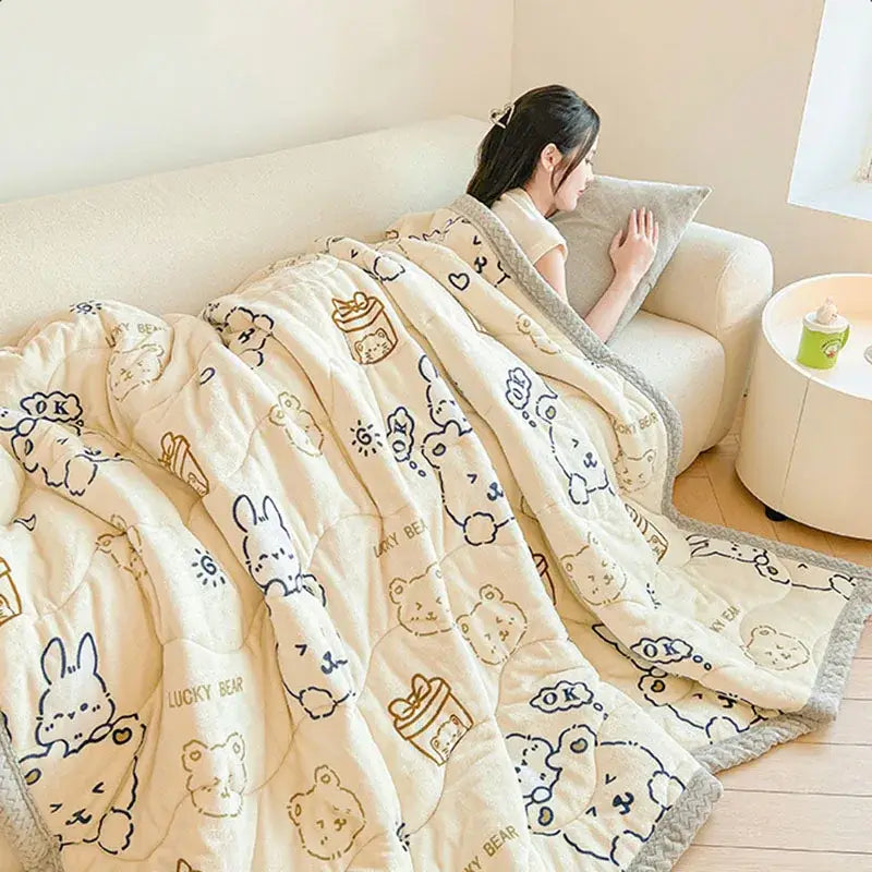 Cream-colored decorbites cartoon print velvet quilted blanket with playful bears bunnies and gray textured trim for bedroom