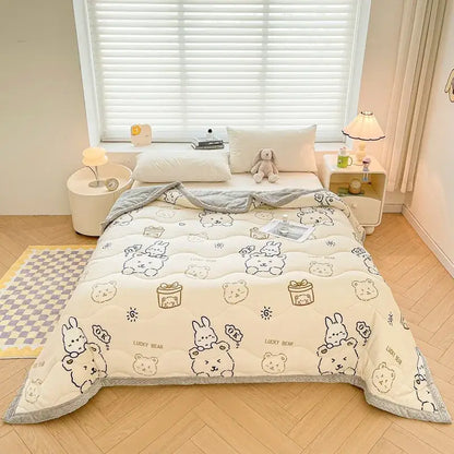 Cream-colored decorbites cartoon print velvet quilted blanket with playful bears and bunnies, soft gray trim
