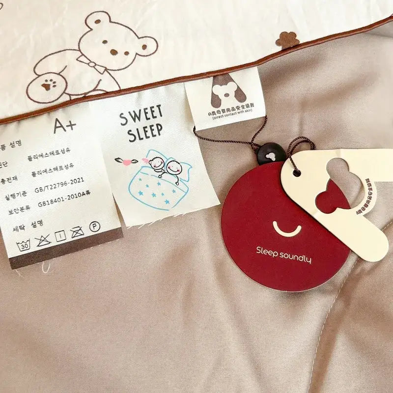 Red circular tag with sleep soundly on decorbites cartoon summer cream teddy bear cotton blanket attached by brown string