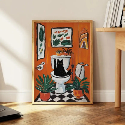 Orange-framed DecorBites™ cat reading wall art showing a black cat on a white toilet with plants and towels on canvas