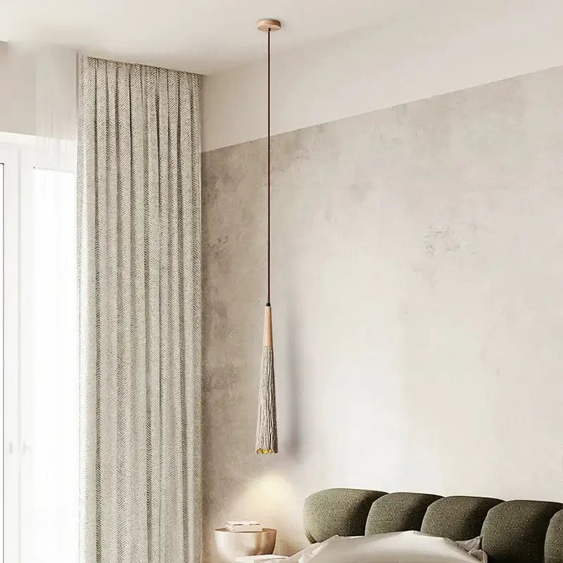 Minimalist pendant light with slender wooden top, gray tassel, and gold accents from decorbites cement cream led series