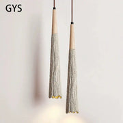 Two gys brand decorbites cement cream led pendant lights with wooden tops and grayish beige tassel bodies for bedside use