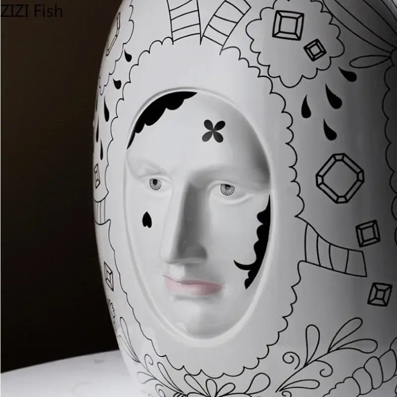 White ceramic vase desktop by DecorBites featuring stylized face with black line art for floral arrangements