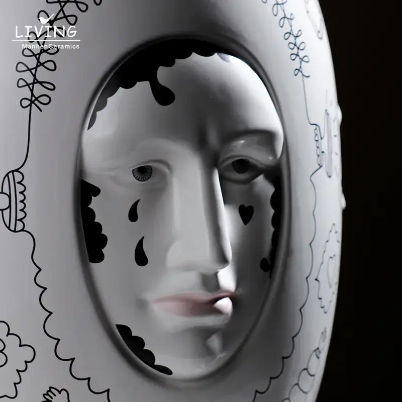 White ceramic vase desktop with black ink-drawn face design and decorative patterns for floral arrangements