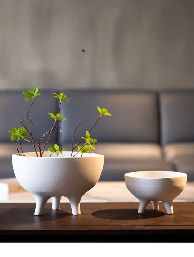 Decorbites ceramic flower pot with tripod stand in white matte ceramic featuring a minimalist tri-legged design