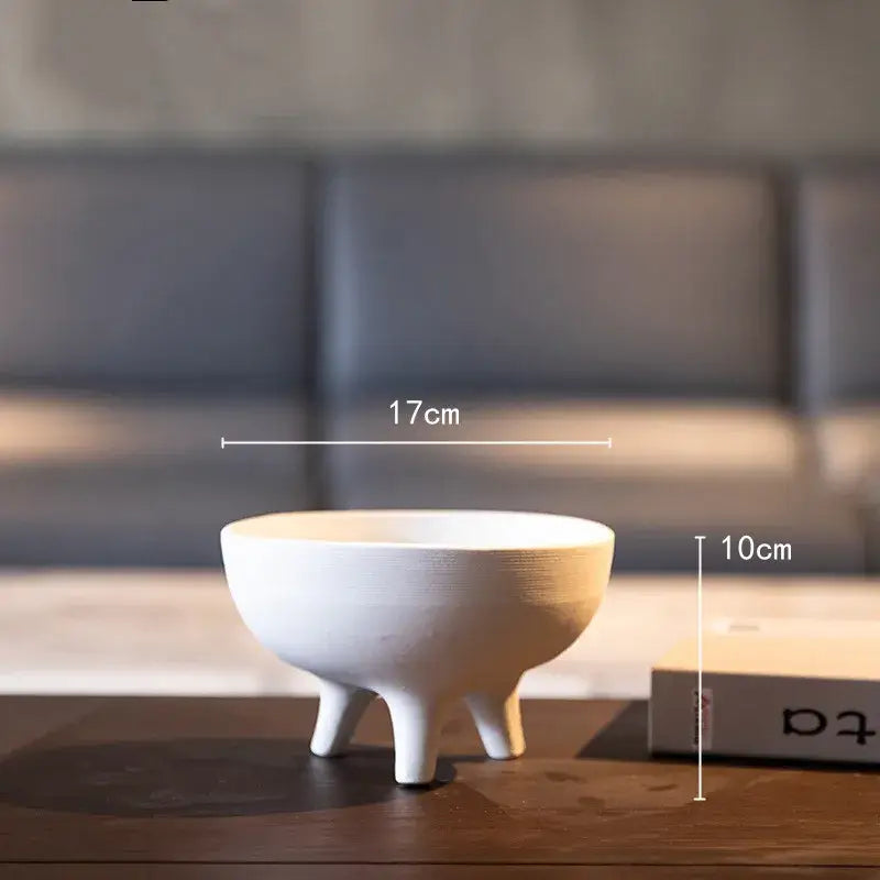 White ceramic flower pot with tripod stand featuring a smooth rounded interior and matte finish by DecorBites™