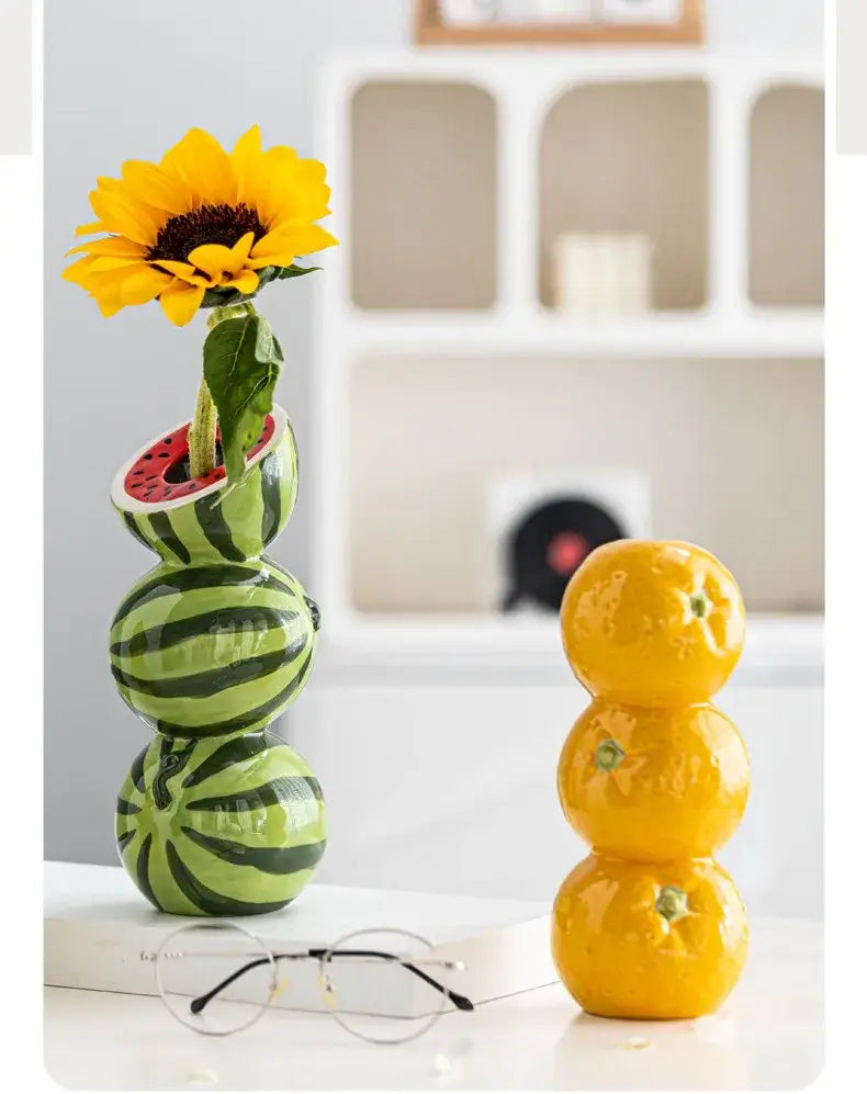 DecorBites™ ceramic fruit vase glossy green watermelon theme with black stripes and red interior holding a yellow sunflower