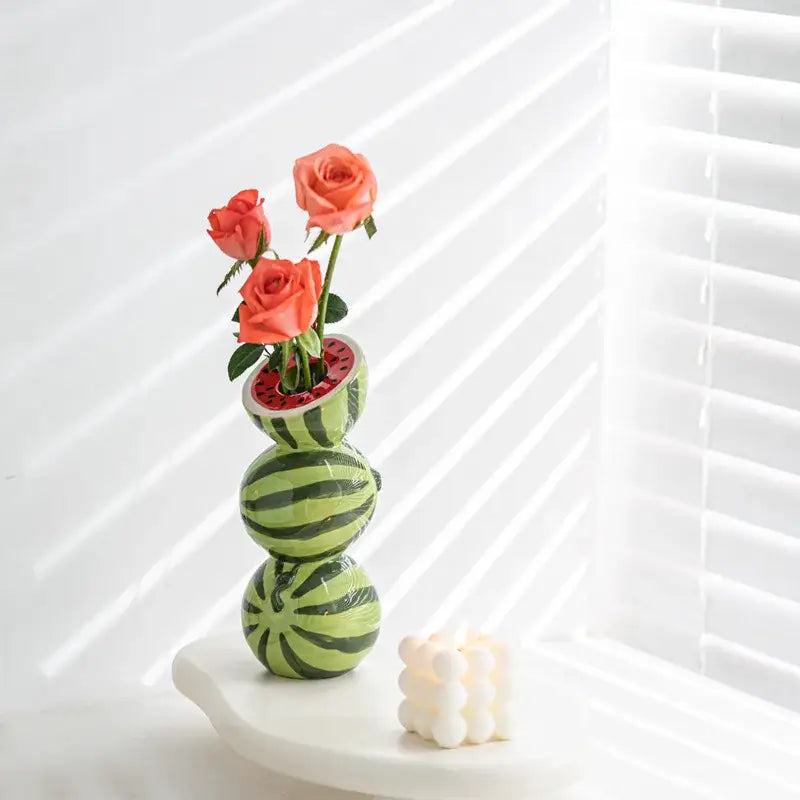 DecorBites™ ceramic fruit vase with stacked watermelon design holding three coral roses for home and office decor