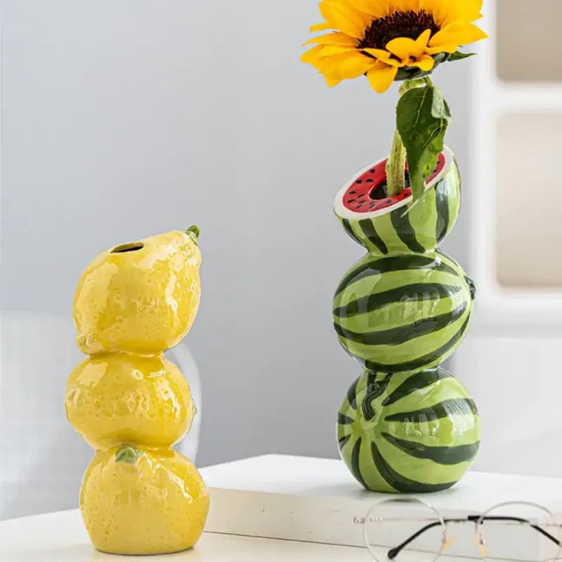 DecorBites™ ceramic fruit vase in vibrant green and black stripes with red interior holding a sunflower for home and office