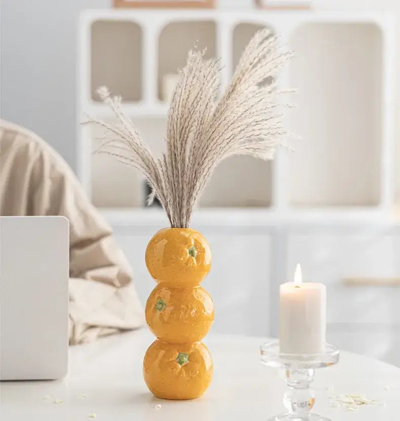 DecorBites™ ceramic fruit vase shaped like stacked yellow oranges with green star details for home and office