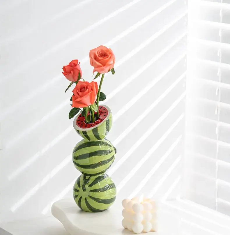 DecorBites ceramic fruit vase shaped like a whimsical watermelon with green stripes and coral roses inside